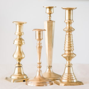 assorted vintage brass candelsticks for wedding hire